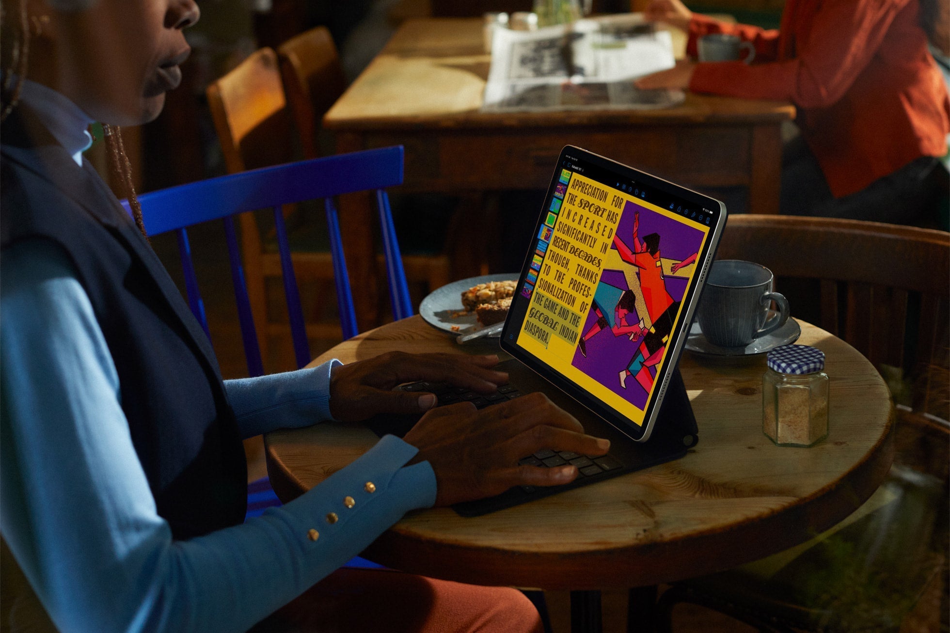 Apple iPad Pro 11-inch (4th Gen) M2, 256GB Wi-Fi Space Gray — lifestyle — working at a cafe with Magic Keyboard